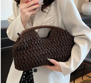 Detailed close-up view of the dark brown paper rope woven clutch bag, retro style shell design.