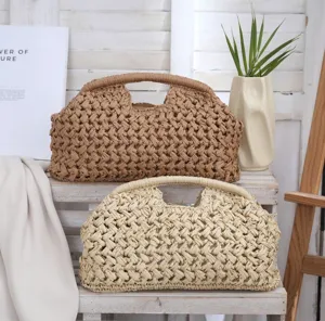 Detail view of woven paper straw shell clutch bag, retro casual beach purse for women.