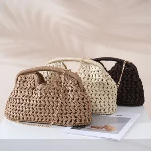 Close-up details of woven paper straw shell handbags with metal chains and sturdy handles.