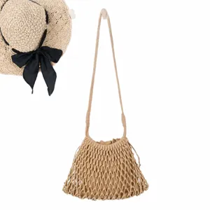 Minimalist cotton rope woven crossbody bag with hollow mesh bucket design and straw hat.