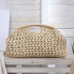 Detail shot of the paper rope woven clutch bag, showcasing natural straw texture and design.