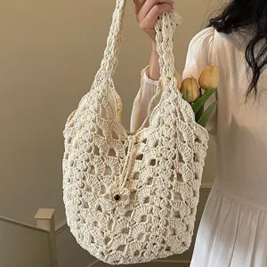 Casual hollow crochet shoulder bag, chic knit armpit handbag, stylish everyday straw tote.
