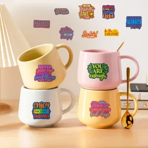 Inspirational quote ceramic mugs and decorative sticker set with colorful motivational text.