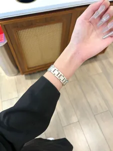 Compatible metal watch band for Apple Watch with elegant silver link design and blue stones.