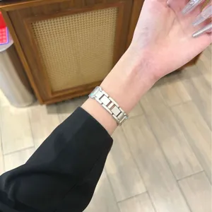 Silver metal link replacement watch band compatible with smartwatches, sleek and durable style.