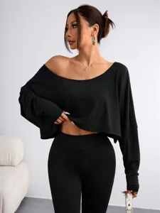 Women black off-shoulder loose crop top and leggings set, stylish long sleeve casual outfit.