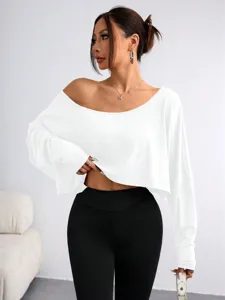 Details of the white off-shoulder loose long sleeve top showing fabric texture and fit style.