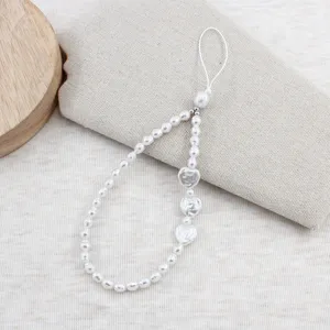 Pearl heart phone charm strap detail, elegant white bead mobile accessory for cute phone case
