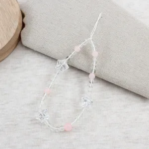 Detailed view of a sweet beaded phone charm featuring clear star and pink round beads.