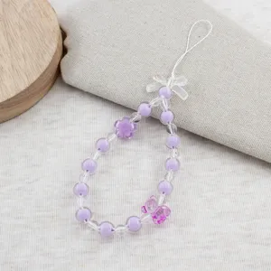 Sweet purple beaded phone charm strap with cute flower and bow accents for cute bags.
