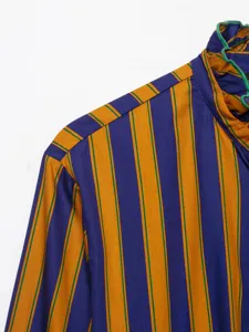 Close-up of women's striped long sleeve blouse with ruffled high collar detail in chic style.
