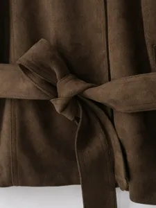 Close-up view of the brown suede jacket waist belt and elegant knot detail, stylish and classic.