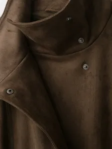 Close-up detail of brown suede jacket stand collar with metal snap buttons, fashion apparel.