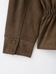 Brown suede jacket detail, women autumn fashion long sleeve outerwear closeup view.