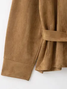 Detail shot of a women's camel suede jacket featuring a matching belt and pocket design.