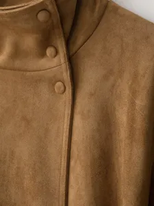 Brown faux suede jacket high collar detail view, soft fabric texture close up shot.