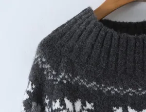Close-up detail of dark grey Fair Isle knitted sweater with soft fuzzy texture and jacquard.
