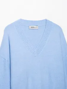 Light blue V-neck knit sweater detail view, showcasing soft fabric and relaxed long sleeves.