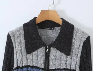 Close-up of the retro lapel, zip-up front, and cable knit pattern on this stylish sweater.