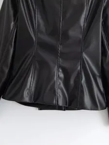 Black faux leather jacket detail view, slim fit back panel with stylish vertical seam design.
