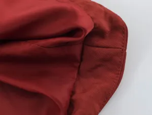 High quality dark red fabric and fine stitching detail of women's casual clothing.