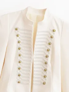 Close-up of vintage stand collar court blazer with gold buttons and white braided embroidery.