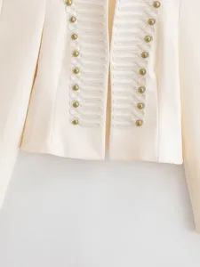 Close up of women vintage military style cropped blazer with gold buttons and cord trim.