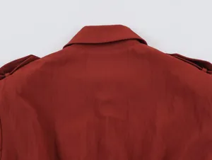 Close up detail view of red womens trench coat back collar and shoulder design.