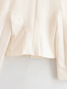 Close-up detail of the cream slim-fit women jacket back, showing tailored panel seam design.