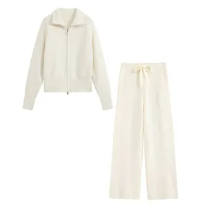 Detailed view of women cozy ribbed knit zip cardigan and elastic drawstring wide leg trousers.