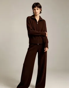 Close-up detail of the elegant brown knitted zip-up cardigan and matching trousers set.