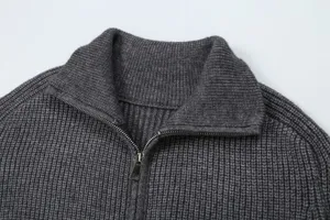 Close-up detail view of the collar and metal zipper on a dark gray ribbed knit sweater.