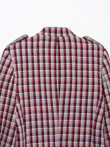 Close-up detail of the back collar and structured shoulders of a tweed blazer jacket.