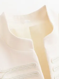 Detail view of women cream mandarin collar blazer featuring elegant white braided trim.