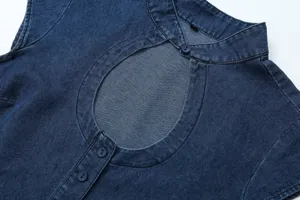 Close up view of the blue denim top featuring a vintage cutout neck and sleeveless design.