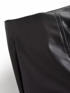 Black faux leather fabric detail view, showcasing fine texture and professional stitching.