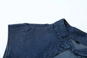 Close-up detail of the dark blue denim sleeveless top showing shoulder and cutout collar.