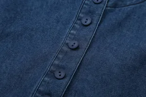 Close-up detail of dark blue denim women's top featuring classic front button placket.