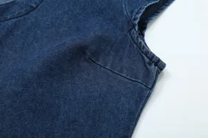 Blue denim sleeveless top fabric detail showing classic texture and stitching close up.