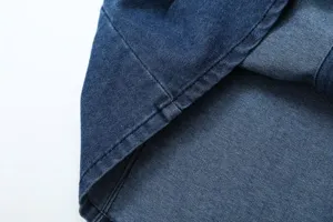 Detailed close-up view of dark blue denim fabric showcasing neat stitching details.