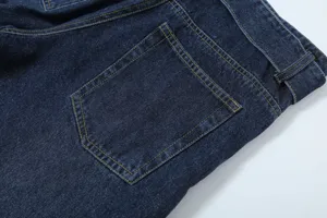 Detail view of women's dark blue wide-leg denim trousers with classic contrast stitching.