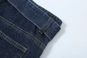 Close-up detail of dark blue denim jeans waistband with classic yellow stitching work.