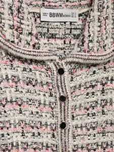 Detailed view of womens autumn tweed knitted cardigan featuring stylish lapel and elegant buttons.