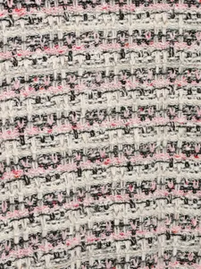 Close-up tweed fabric detail shot, multi-color woven knit texture for women's cardigan.