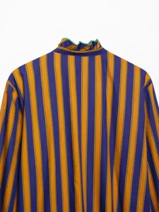 Detailed view of women long sleeve striped shirt with ruffled high collar purple and yellow pattern.