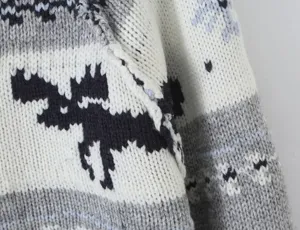 Close-up detail of vintage Nordic elk patterned knit cardigan sweater winter fashion.