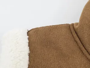 Close up of brown suede and white sherpa fleece splice detail on women vest coat.