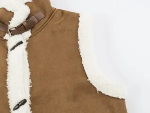 Close-up detail of women's brown fleece patchwork vest featuring horn buttons and a chic collar strap.