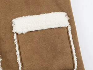 Brown shearling spliced vest pocket detail, autumn winter warm fleece outerwear closeup.