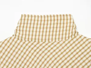Brown white plaid high collar detail of casual women jacket closeup view showing fabric texture